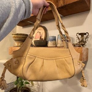 Cole Haan camel color pebble leather bag w/tassels and braided leather straps